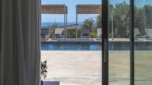 A modern outdoor pool area with a clear view of the ocean and a covered seating area. - Dietro al Muro - Four Bedroom Villa, Sleeps 10 (Avola)