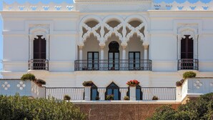A white building with ornate arches and balconies, featuring a symmetrical facade and decorative elements. - Luna Rossa - Four Bedroom Villa, Sleeps 8 (Castrignano del capo)