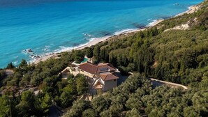 A coastal property with a large house surrounded by dense forest, a beach, and the sea. - Madreterra - Six Bedroom Villa, Sleeps 12 (Lefkada)