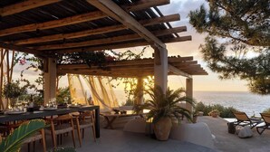 An outdoor dining area with a pergola, tables, chairs, and potted plants. - Madreterra - Six Bedroom Villa, Sleeps 12 (Lefkada)