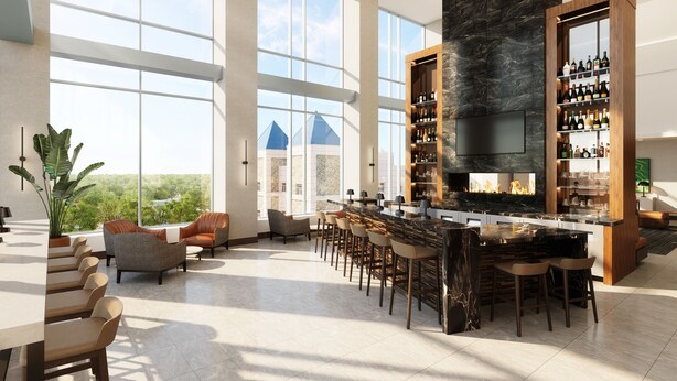 A spacious bar area with a large TV screen, a fireplace, and a wine rack. - Highpoint Hotel (Sioux Falls)