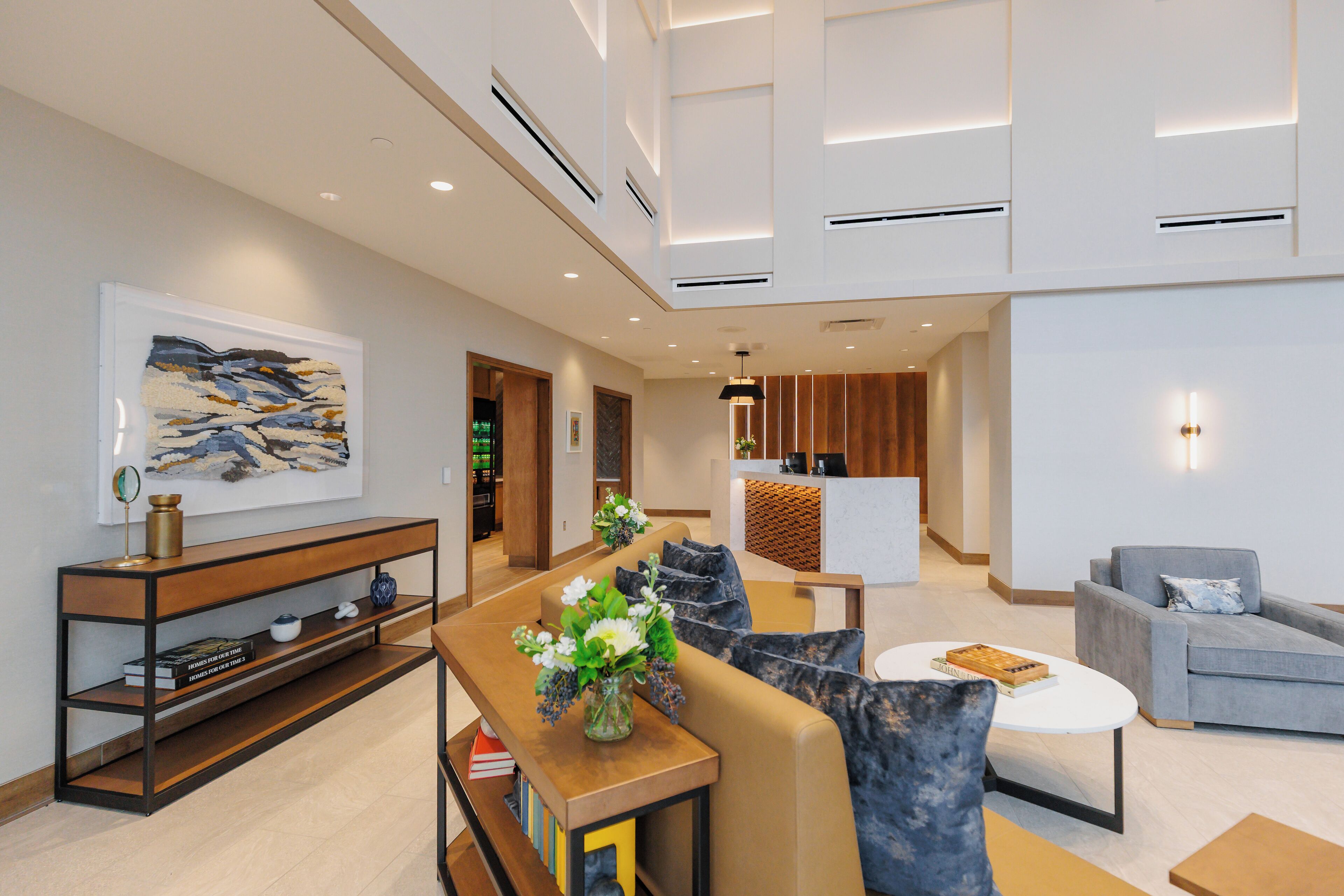 A modern living room with a sofa, coffee table, and a console table with decorative items.