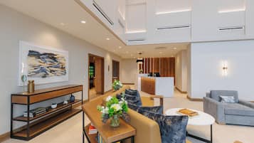 A modern living room with a sofa, coffee table, and a console table with decorative items.