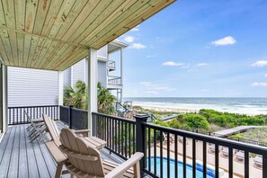 A wooden deck with lounge chairs, a pool, and a view of the beach and ocean. - Headed West - Private Pool, Beach Front, Pet Friendly, Beach Gear Included! (St. George Island)