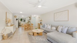 A spacious living area with a sofa, coffee table, and dining table. - Tugun Bliss - Absolute Beachfront in Tugun - Min. 3 Night Stays - Linen Provided (Tugun)