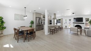 A modern kitchen with stainless steel appliances, a central island, and a built-in oven. - Austin Escape: Stylish 3BR/4 Beds + Private Pool (Austin)