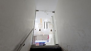 A hotel interior with a staircase leading to a reception area labeled "HOTEL URBAN VIEW." - Hotel Urban View (Ahmedabad)