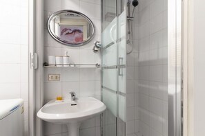 Shower, hair dryer, towels, toilet paper