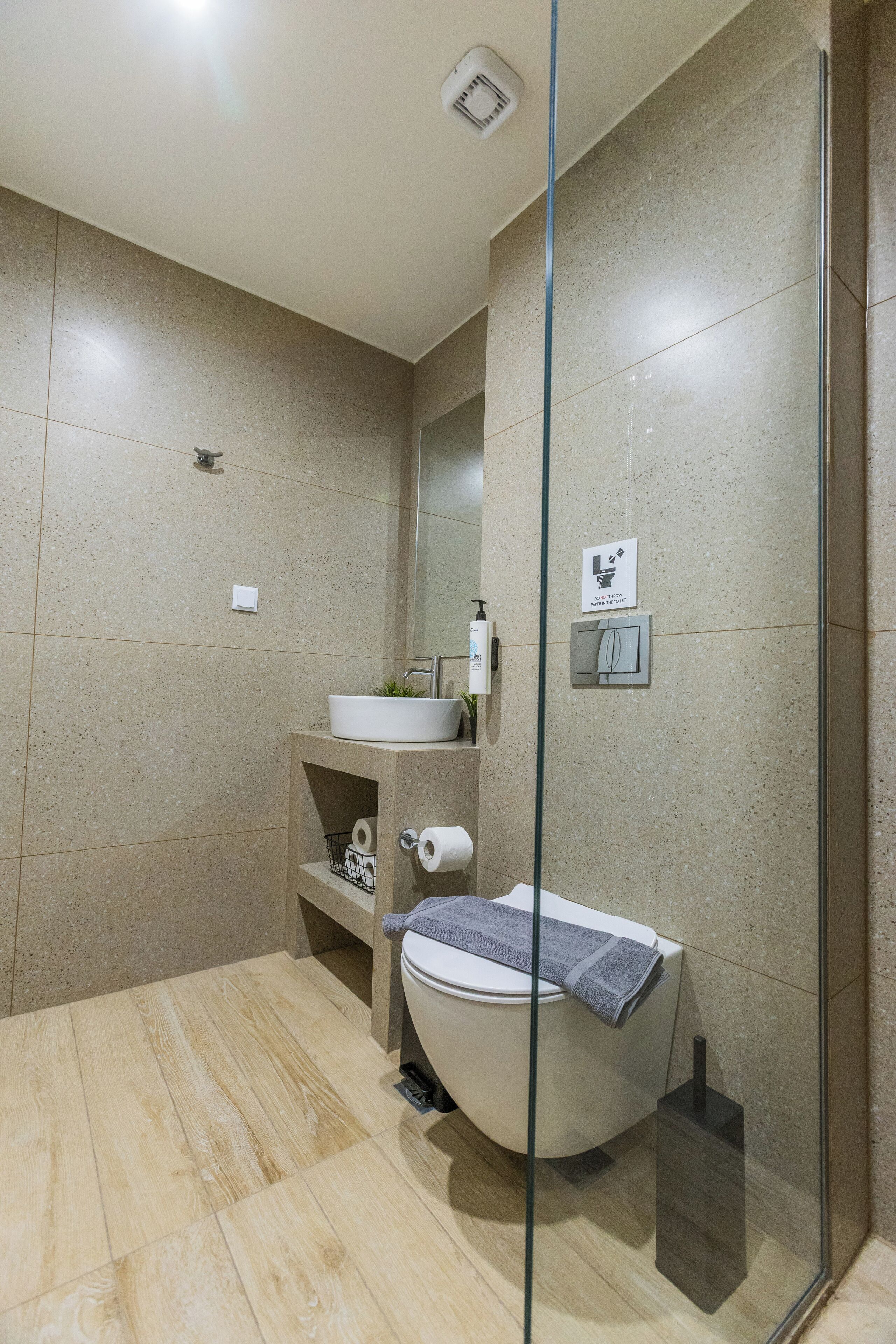 A modern bathroom with a freestanding bathtub, a toilet, and a sink.