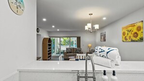A modern bathroom with a sink, faucet, and toiletries.