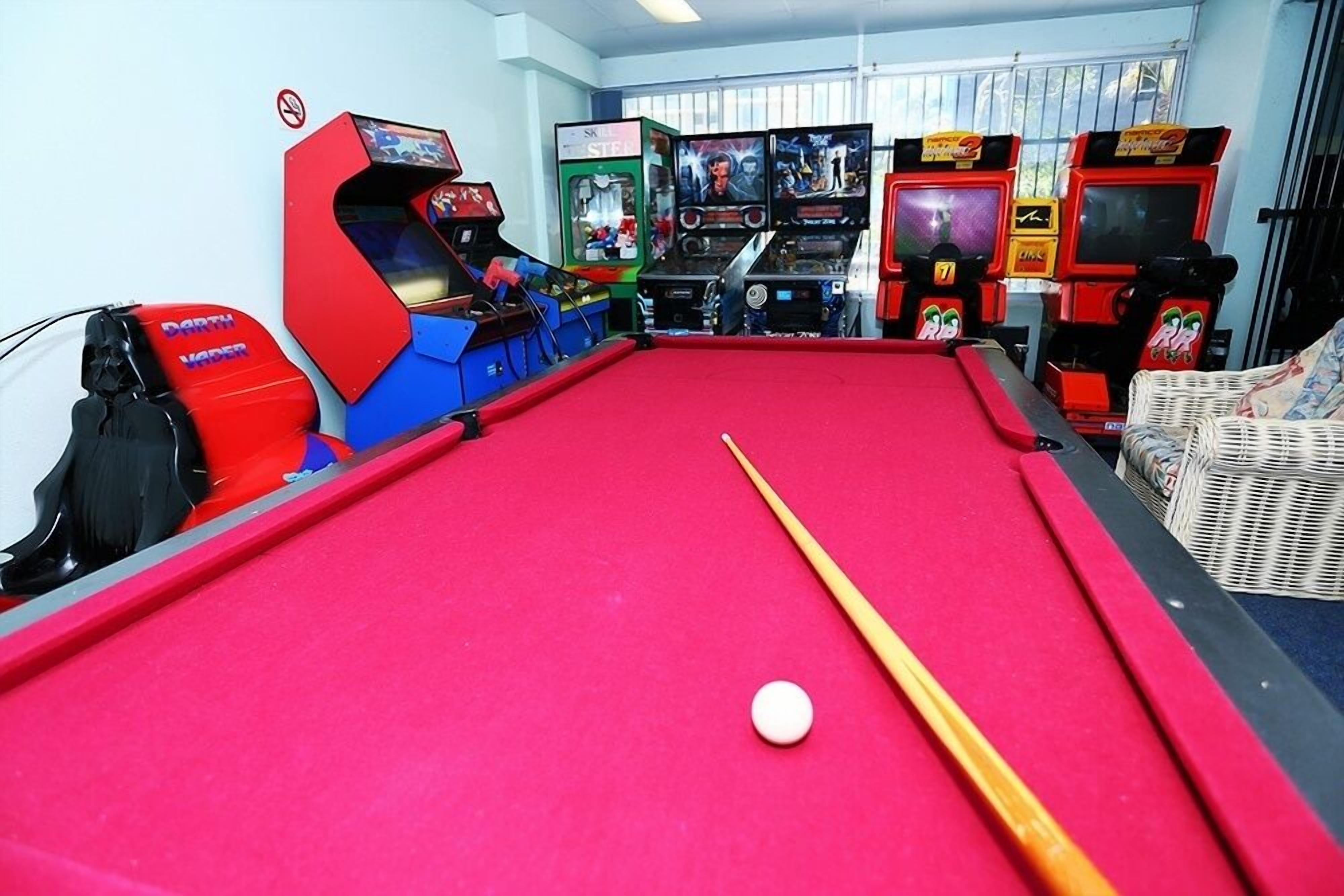 Games room with arcade machines, billiards and air hockey for indoor fun onsite.