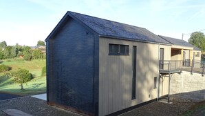 A small, single-story building with a sloped roof and a wooden door.
