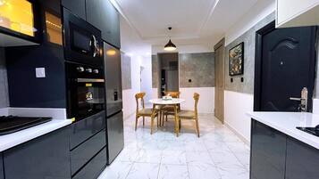 Family Apartment, Balcony, City View | Private kitchen | Fridge, microwave, oven, stovetop