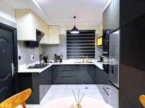 Family Apartment, Balcony, City View | Private kitchen | Fridge, microwave, oven, stovetop