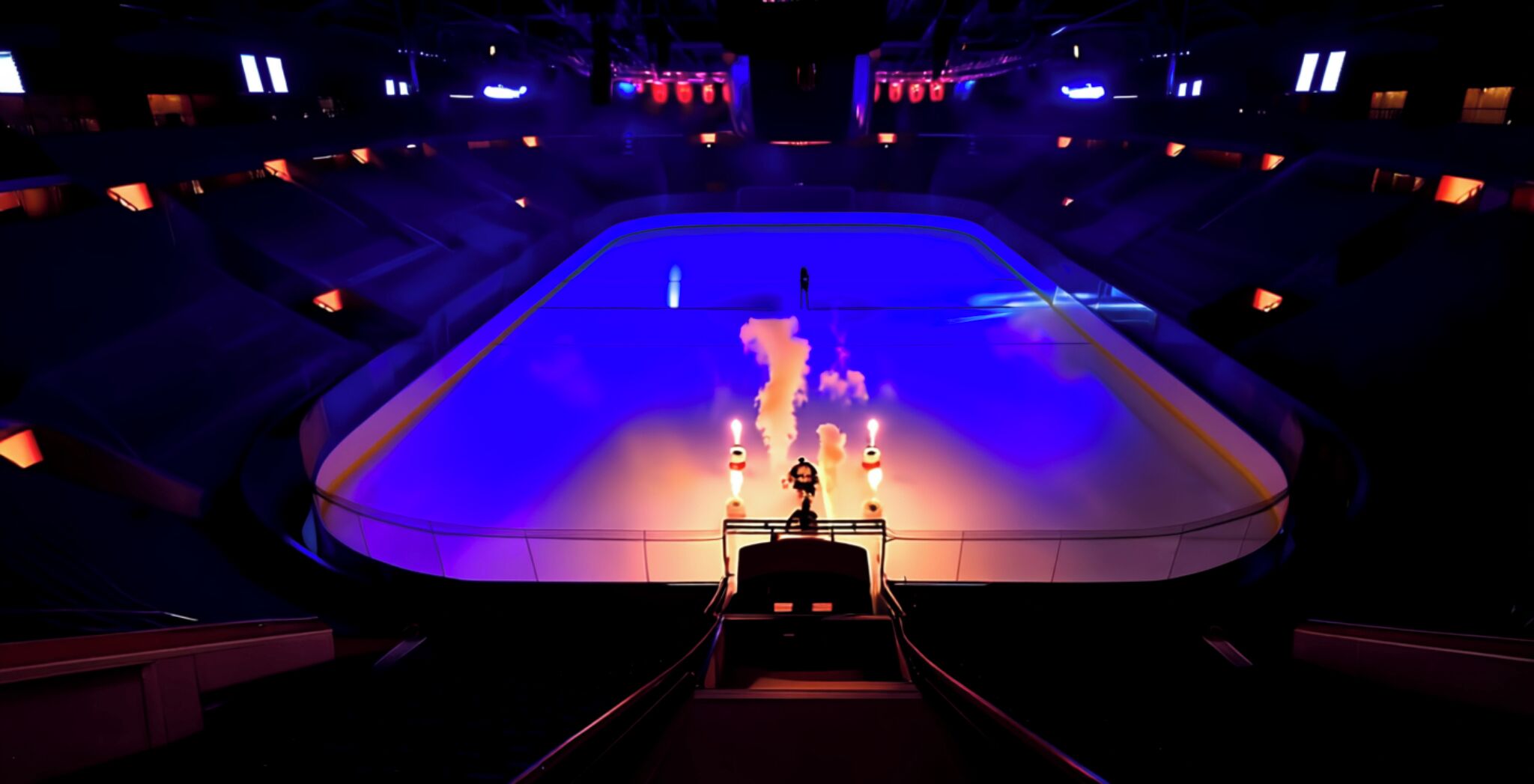 A stage with a central platform and two large speakers.