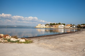 A coastal area with buildings near the water, a sandy beach, and a clear sky. - Holiday Home 'Mexico' with Balcony and Air Conditioning (Saint-Mitre-les-Remparts)