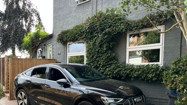A black SUV parked in front of a house with a grey exterior and a wooden fence. - Charming countryside cottage near Canterbury, Kent (Bekesbourne)