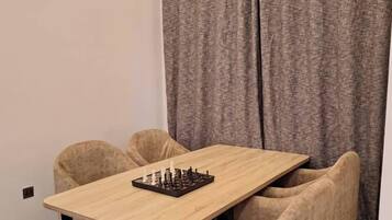 Deluxe Apartment, Balcony, City View | Dining room