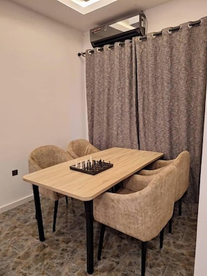 Deluxe Apartment, Balcony, City View | Dining room