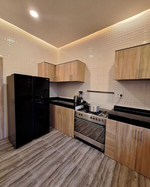 Deluxe Apartment, Balcony, City View | Private kitchen | Fridge, microwave, oven, stovetop