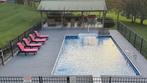 A rectangular pool with a lifeguard station and lounge chairs. - Your Perfect Creekside Hideaway (Rabun Gap)