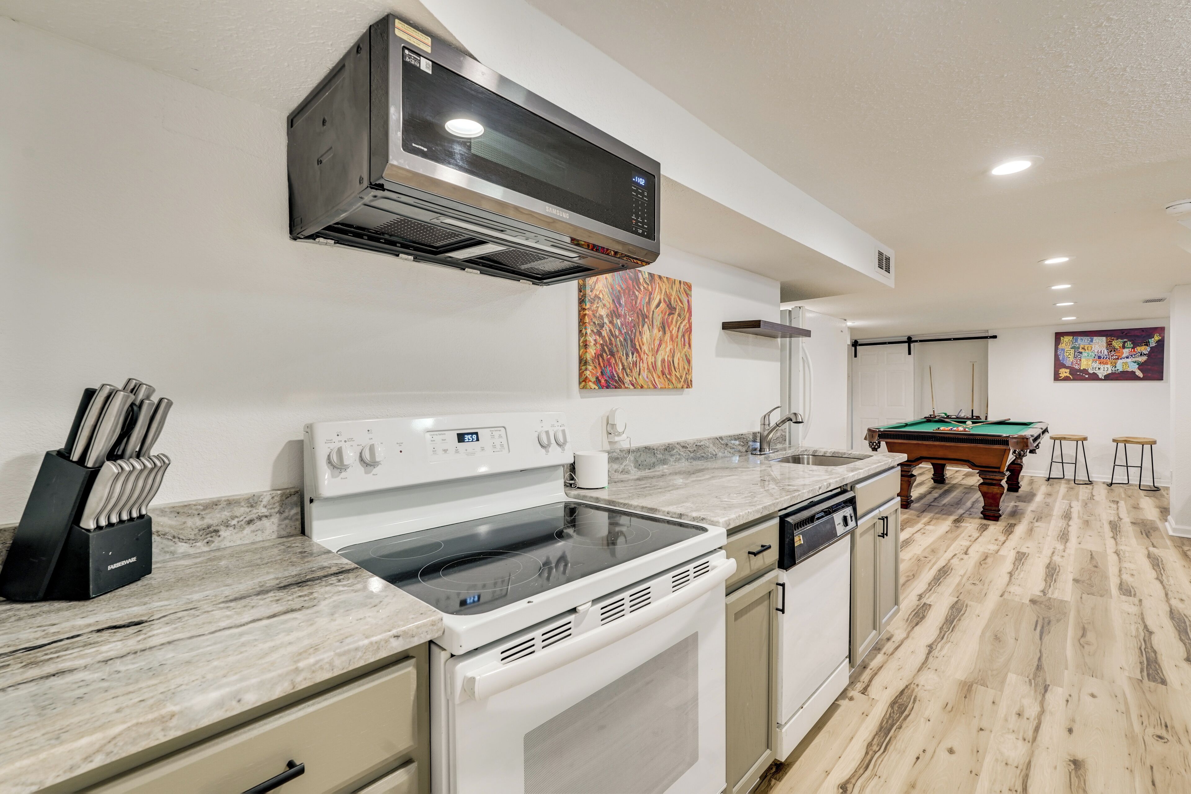 A modern kitchen with a built-in stove, microwave, and dishwasher.