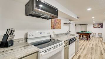 A modern kitchen with a built-in stove, microwave, and dishwasher.
