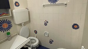 A bathroom with a toilet, bidet, and sink.