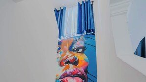 A staircase with a colorful mural on the wall.