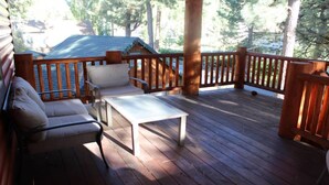 A wooden deck with a sofa, a small table, and a chair. - Aspen Glen Big Bear Lake (Big Bear Lake)