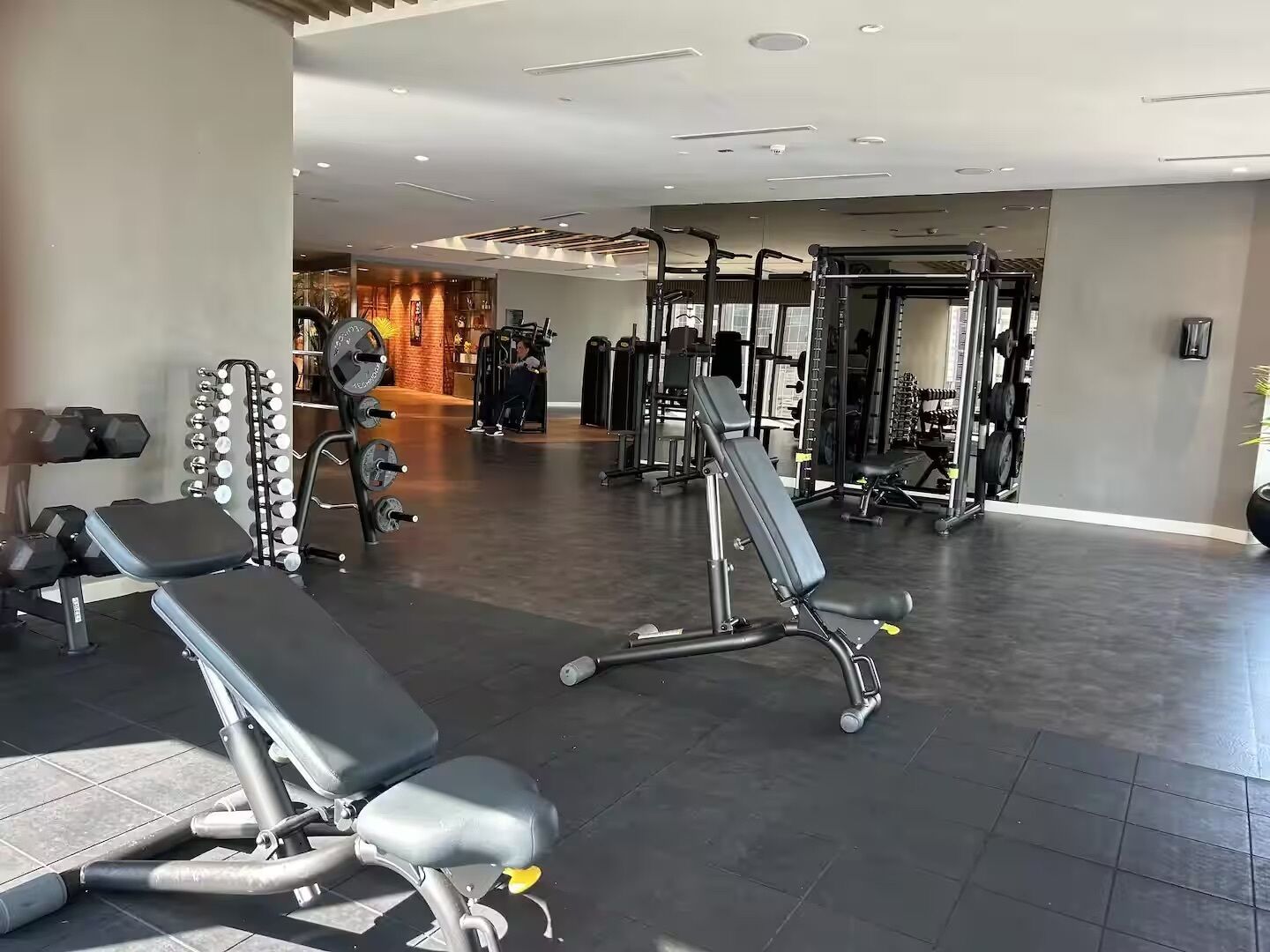 A gym with various exercise equipment, including weight machines and free weights.