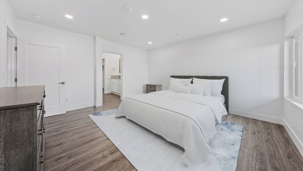 A bedroom with a bed, bedside table, and a view of a hallway. - Unwind in this stylish, newly renovated 1-bedroom suite near Topaz Lake. (Gardnerville)