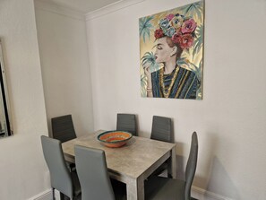 A dining area with a table, chairs, and a decorative bowl.