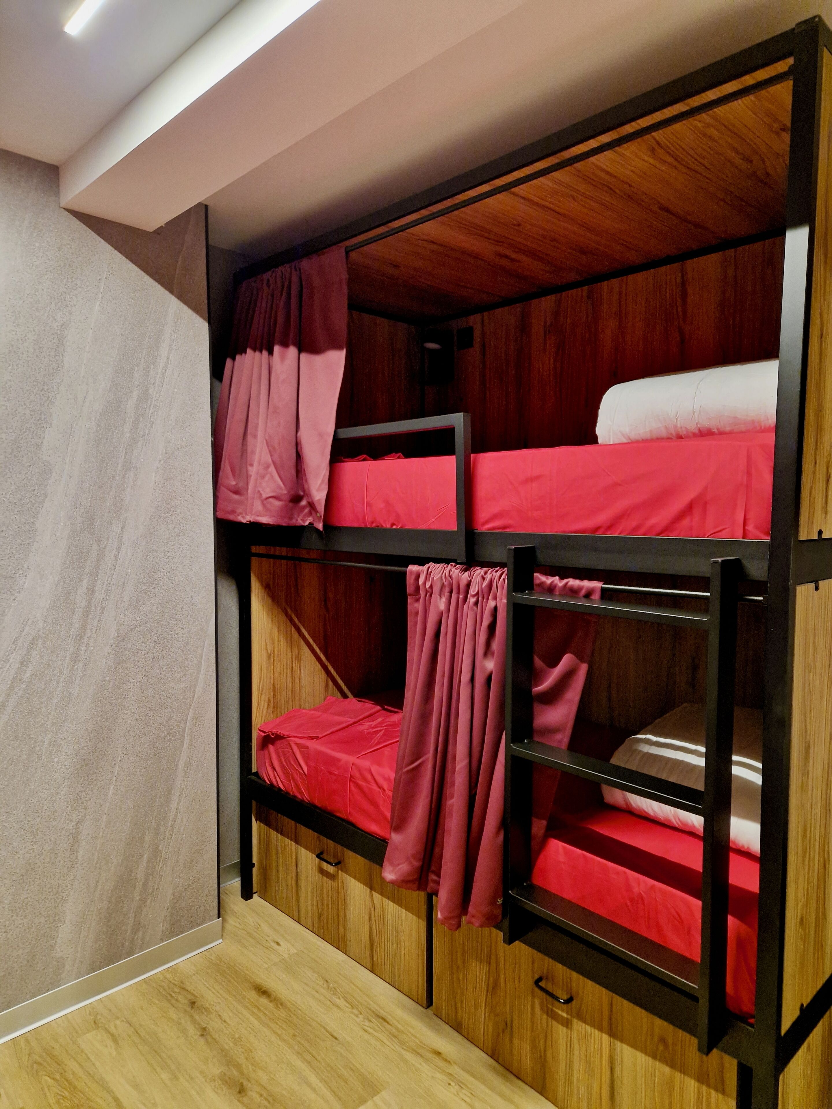 A bunk bed room with wooden walls and a light-colored floor.