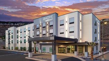 A modern hotel with a sign reading 'HOME Best Western' and the number 333.