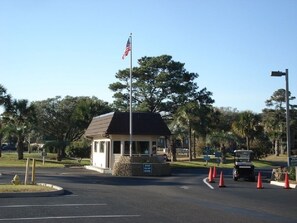 A small building with a flag, surrounded by trees and orange traffic cones. - 2-Bdrm Condo Meets Family Desires - Beachfront Resort - Full Amenities - C13 (Hilton Head Island)