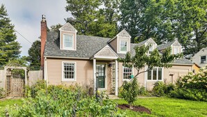 A two-story house with a front porch, a chimney, and a well-maintained garden. - Burlington Escape By Lake Champlain & Bike Path (Burlington)
