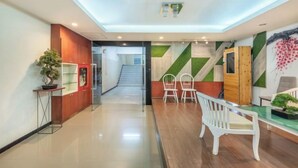 A modern hotel lobby with a glass partition, a staircase, and a reception desk. - Shibaroom Nakhonratchasima Central Korat (Nakhon Ratchasima)
