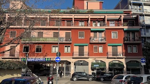 A multi-story building with balconies, a garage, and storefronts. - Casetta Martesana - new one-bedroom apartment on the naviglio (Milano)