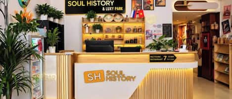 A reception desk with a sign reading 'SOUL HISTORY & LUXY PARK' and a list of cities including London, Moscow, and New York.