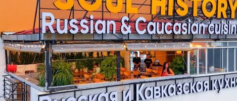 A food stall with a sign reading 'SOUL HISTORY Russian & Caucasian cuisine'.