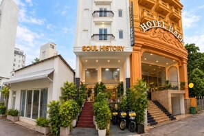 A hotel with a prominent entrance, a staircase leading to the lobby, and a sign reading 'SOUL HISTORY'. - Soul History Hotel Phu Quoc (Phu Quoc Island)