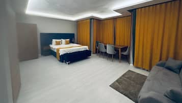 Deluxe Studio Suite, Balcony, City View | Desk, laptop workspace, soundproofing, iron/ironing board