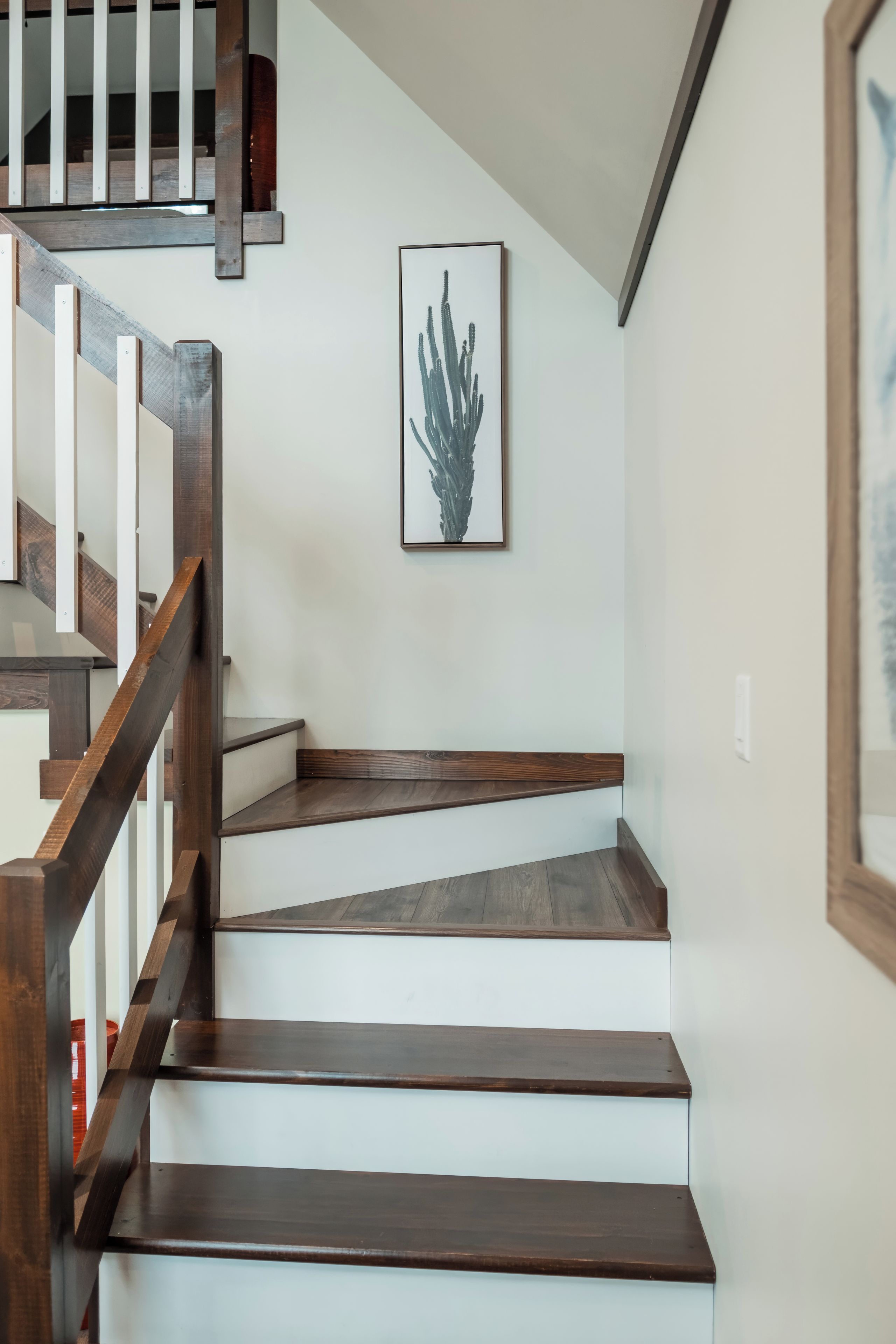 A staircase with wooden steps and a white wall.