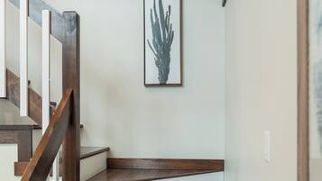 A staircase with wooden steps and a white wall.