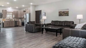 A modern living room with a dark brown leather sofa, a coffee table, and a fireplace. - Accessible Escape- Completely Handicap accessible! (Council Bluffs)