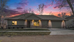 A single-story house with a garage, a front porch, and a well-maintained lawn. - Accessible Escape- Completely Handicap accessible! (Council Bluffs)