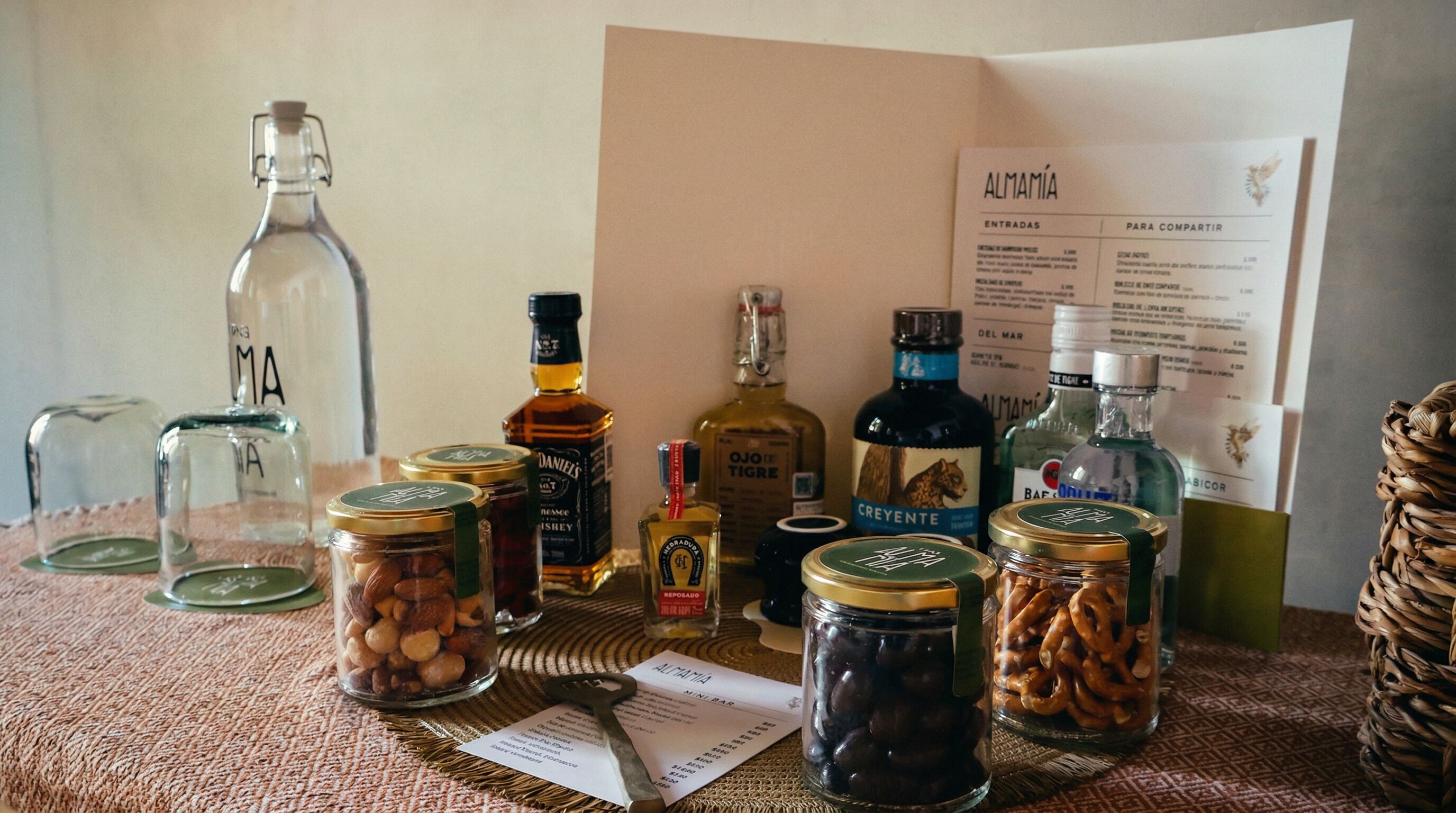 A table with various food items, bottles, and a menu.