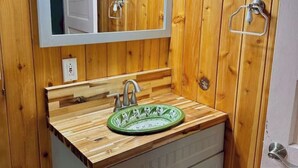 A wooden bathroom with a green sink, a mirror, and a towel rack. - Cozy Casita 1bd/1bth 3 min to Farmer's Market (Las Cruces)