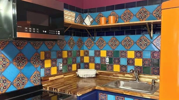 A kitchen with colorful tile backsplash, wooden countertop, and stainless steel appliances. - Cozy Casita 1bd/1bth 3 min to Farmer's Market (Las Cruces)